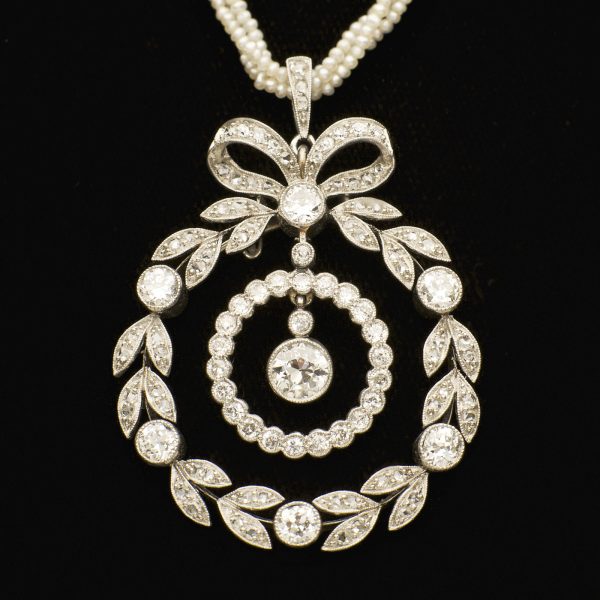 Edwardian diamond pendant designed as a circular wreath and bow