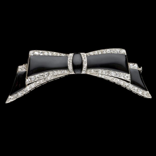 Art Deco platinum diamond and onyx bow brooch. English c.1930