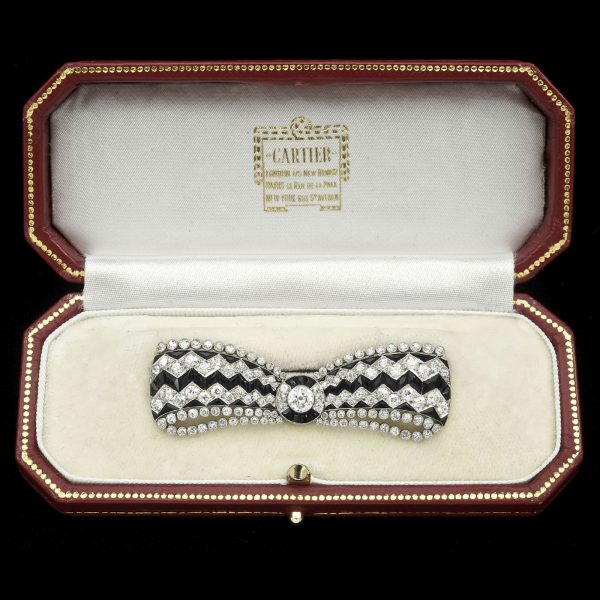 Art Deco onyx and diamond bow brooch in platinum setting marked Cartier c.1930. Original Cartier case
