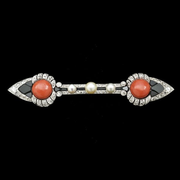 Art Deco double arrow head brooch set with coral, diamonds, onyx and pearls, platinum setting