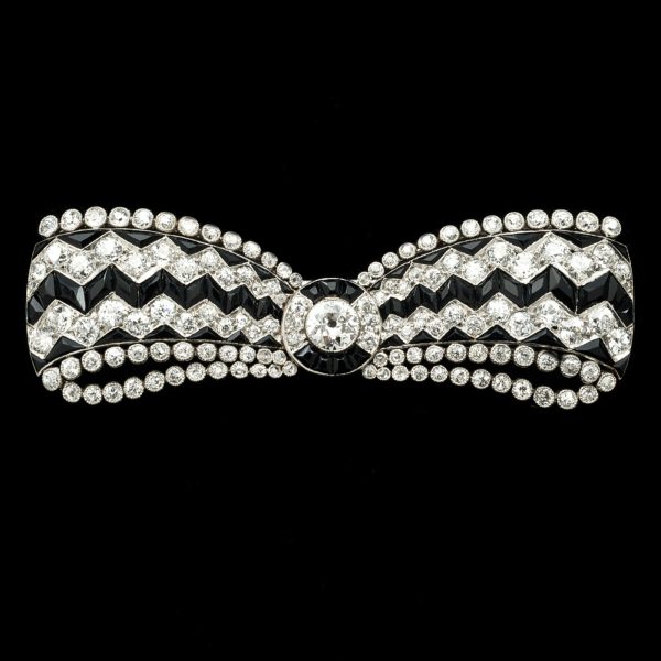 Art Deco onyx and diamond bow brooch in platinum setting marked Cartier c.1930. Original Cartier case