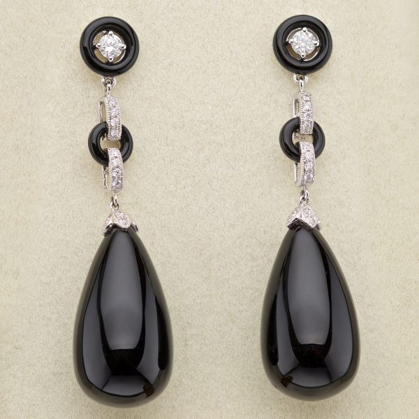 Art Deco style onyx and diamond earrings, the onyx pendants suspended from diamond and onyx links