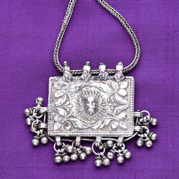 Rectangular box pendant with Surya (sun god) and clumps of beads