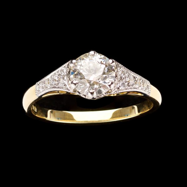 Diamond ring the central stone 0.77ct in diamond set platinum & 18ct yellow gold setting