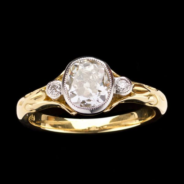 Diamond solitaire ring, the 1.07ct diamond in rubover platinum setting, the shoulders set with diamonds